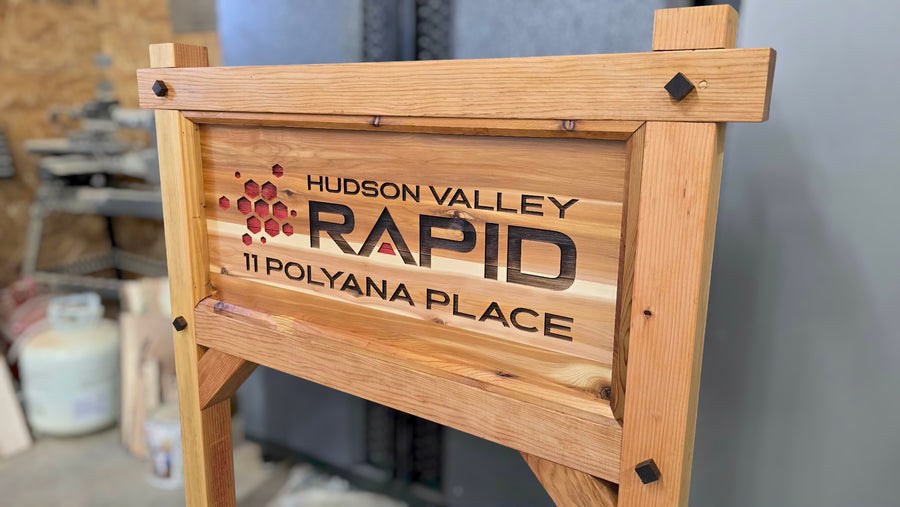 large Wooden business sign with RAPID branding in a workshop setting